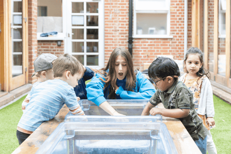 Monkey Puzzle Day Nursery Epping Kids Playing Children engaging in outdoor water activity at Monkey Puzzle Day Nursery Epping.