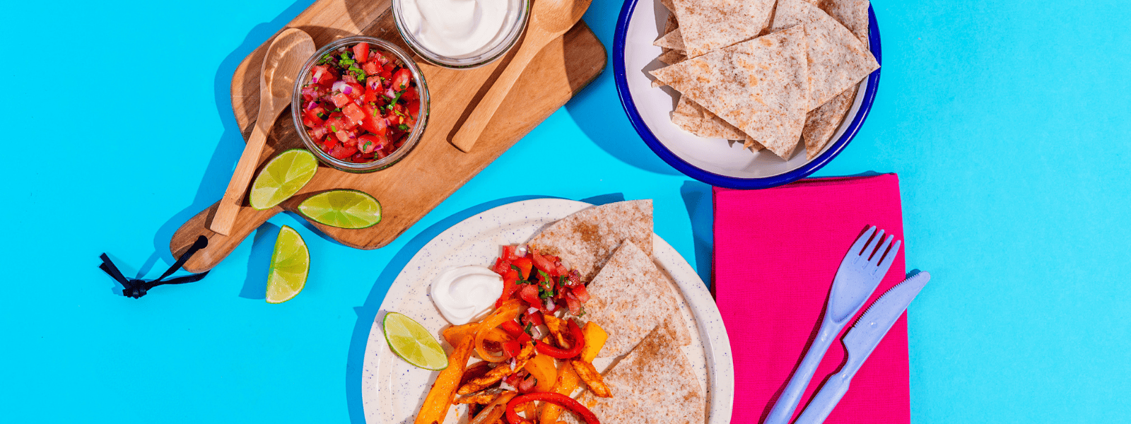 Fresh homemade Mexican tacos with colorful vegetables, salsa, and lime slices served at a children's-friendly snack time setup, emphasizing healthy eating at Monkey Puzzle Day Nurseries.