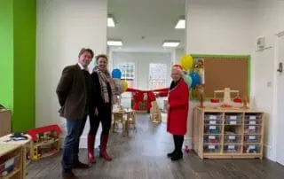 Brightly decorated indoor play area at Monkey Puzzle Day Nurseries, featuring colorful toys, educational materials, and balloons for children's activities.