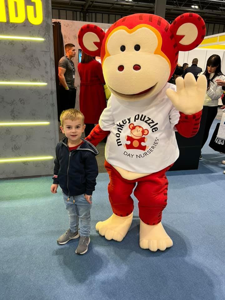 Child meeting Marvin the Monkey at the Franchise Exhibition