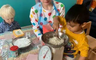 Bright young children engaging in fun sensory activities at a colorful Monkey Puzzle Day Nursery classroom, promoting early childhood development and hands-on learning experiences.