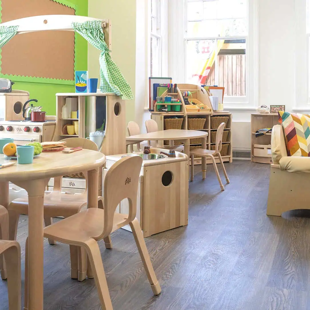 Bright and inviting indoor play area at Monkey Puzzle Day Nurseries, featuring wooden furniture, toys, and learning resources in a colorful, child-friendly environment.