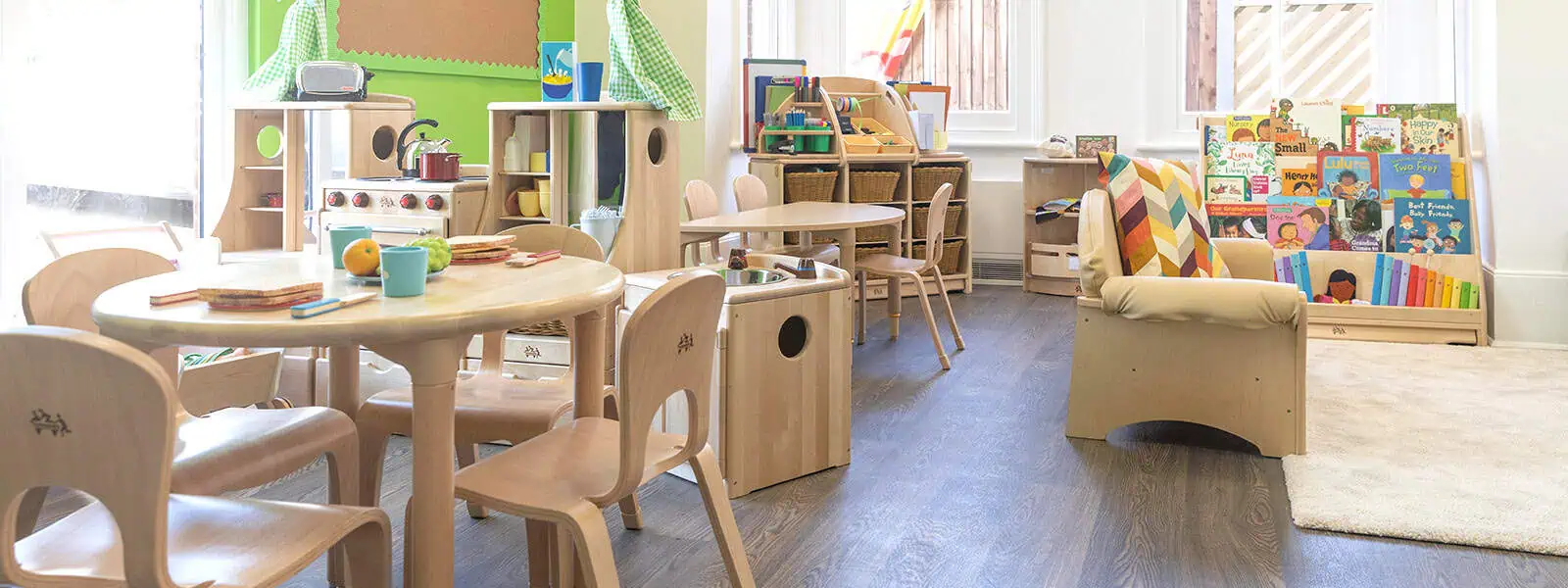 Bright, inviting classroom at Monkey Puzzle Day Nurseries with child-friendly furniture, colorful books, and educational toys, creating a safe and engaging environment for early childhood development.