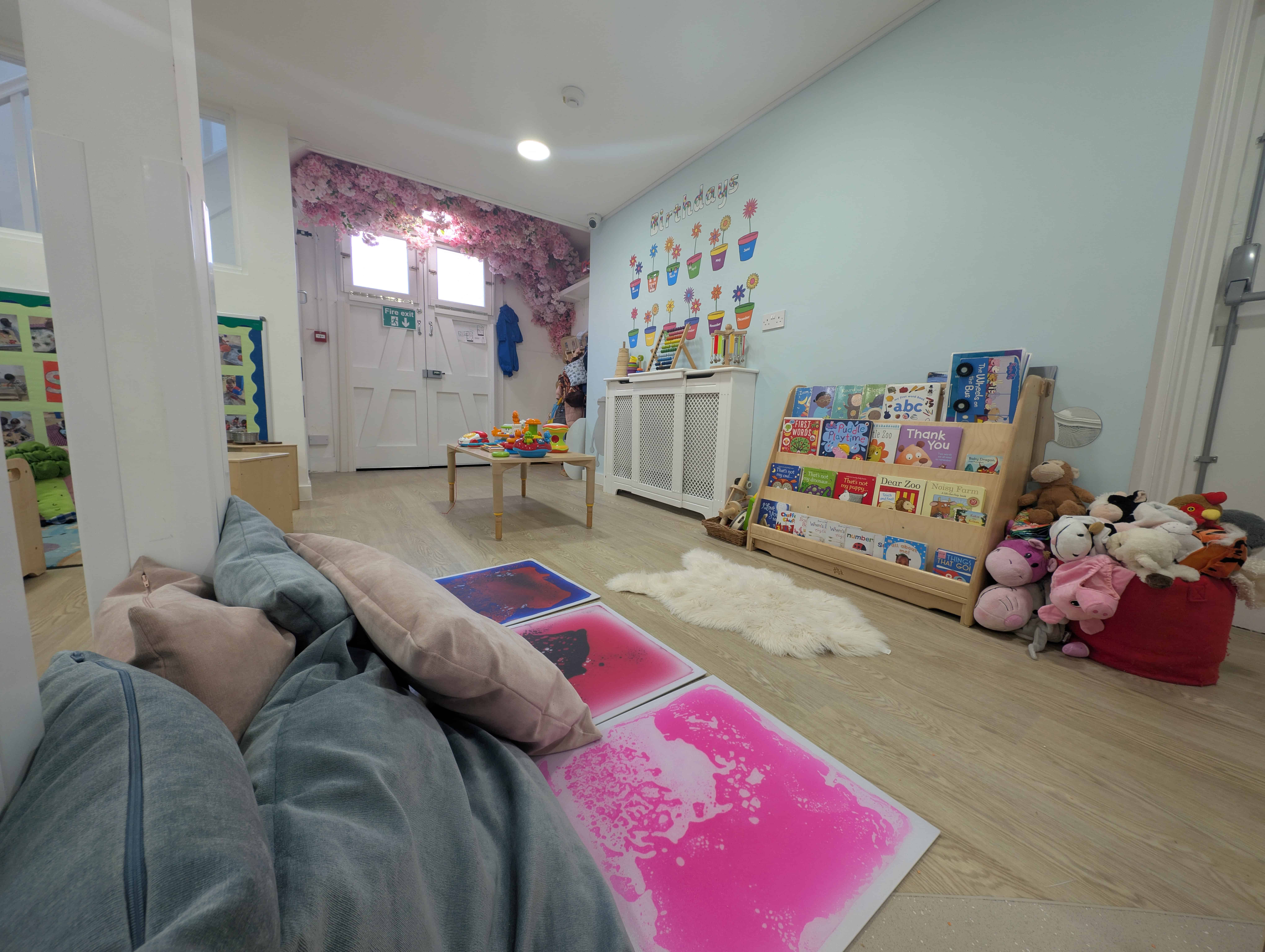 Bright and welcoming nursery play area at Monkey Puzzle Streatham Common, featuring soft mats, toys, and colorful decorations designed for early childhood development and learning.