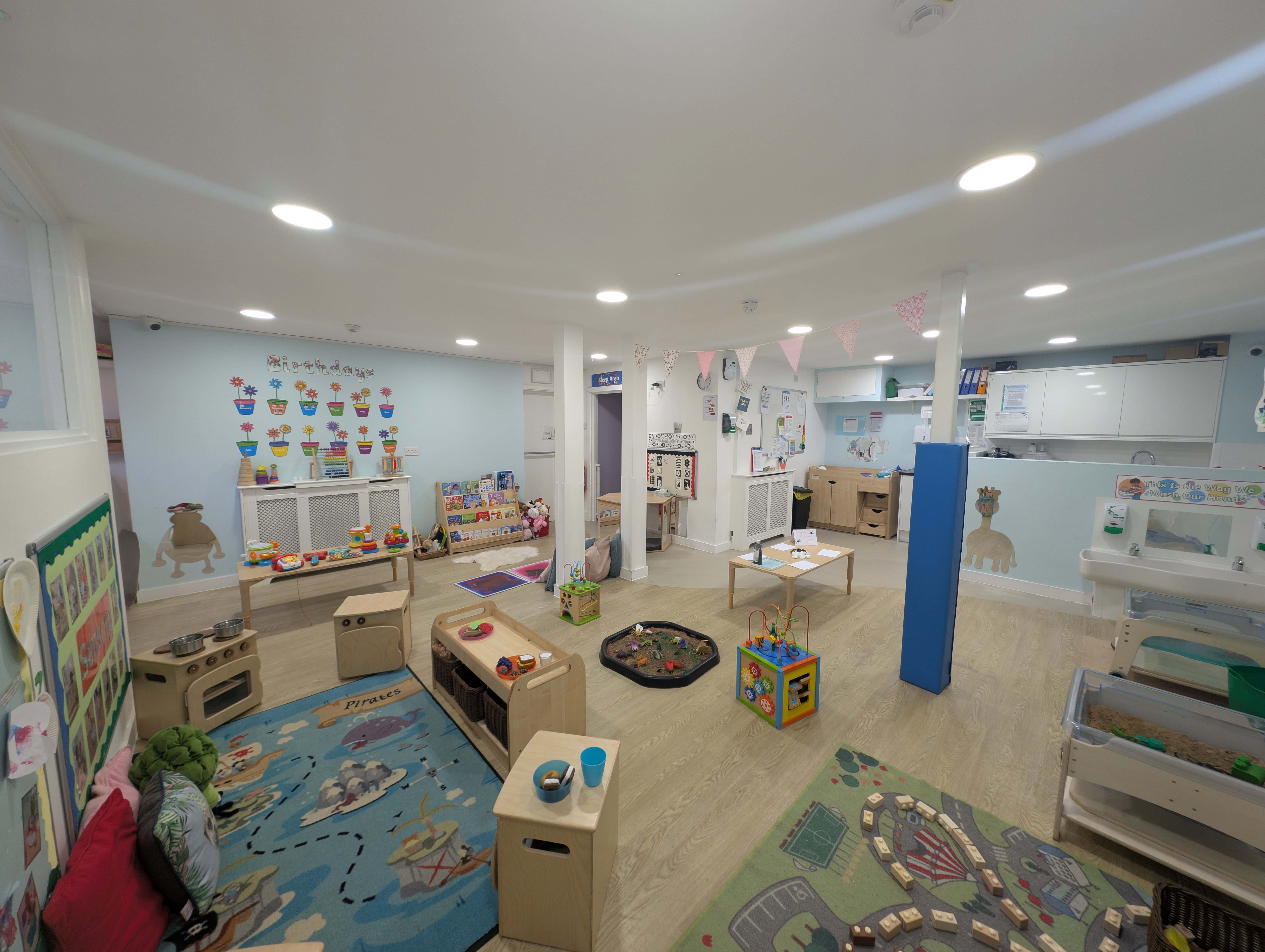 A colorful, well-organized nursery room designed for early childhood development and play activities.