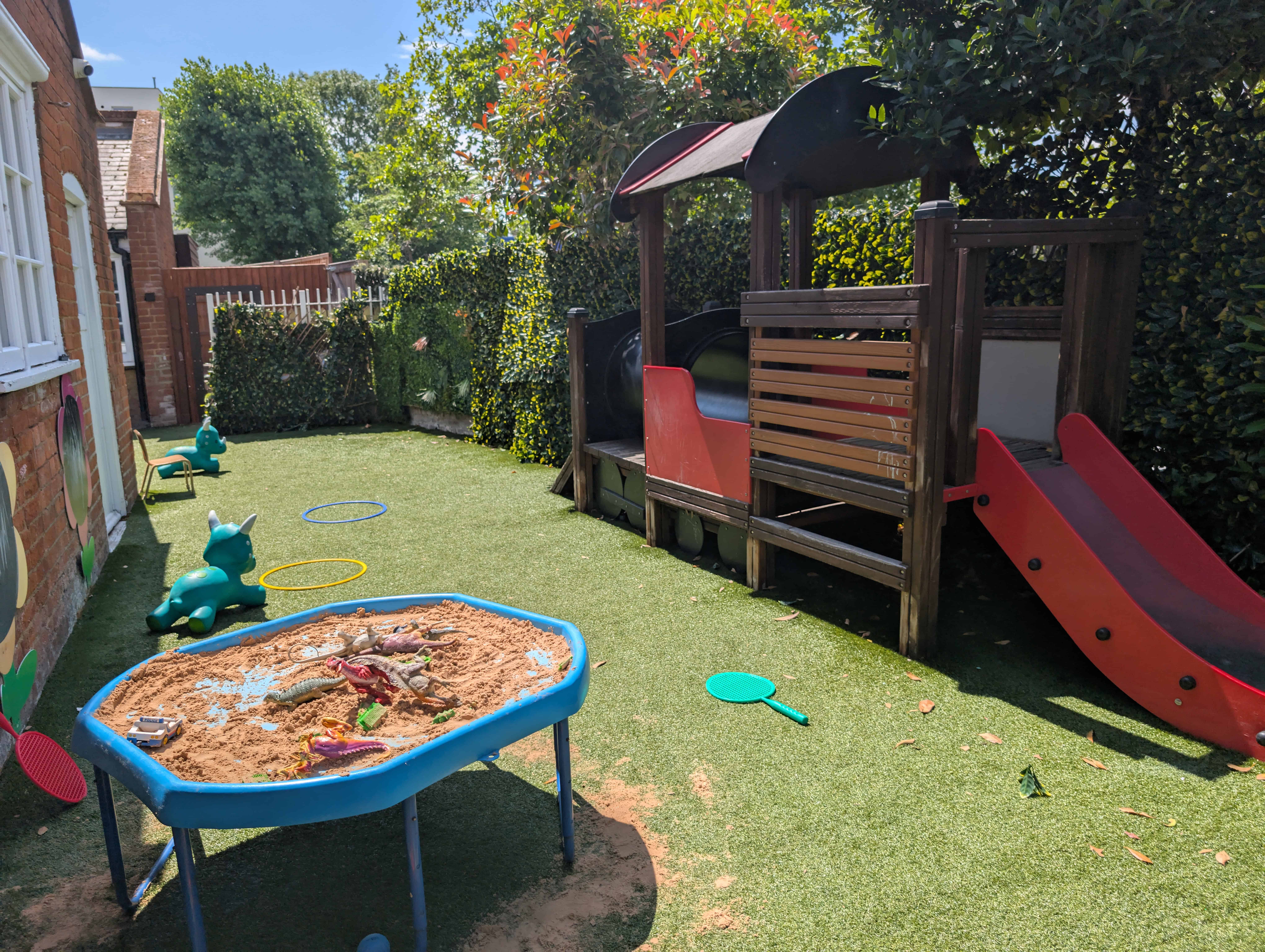 Playground with sandpit and slide at Monkey Puzzle Day Nurseries, Streatham Common.