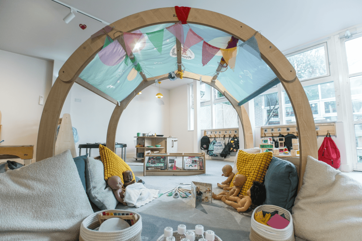 Indoor play area with soft toys and sensory elements at Monkey Puzzle Olympia nursery.