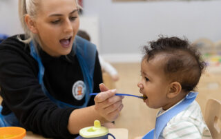 Monkey Puzzle practitioner feeding a child at meal time