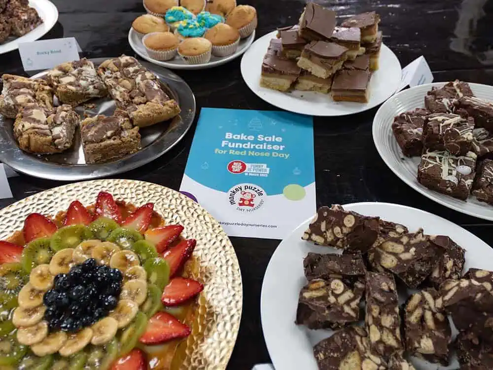 Bake sale cakes Delicious homemade brownies and baked goods displayed on plates for a fundraising event at Monkey Puzzle Day Nurseries. Perfect for children and family-friendly activities.