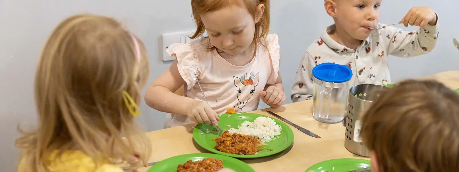 Children enjoying lunch at Monkey Puzzle Day Nurseries, engaging in social and nutritious mealtime activities for early childhood development.
