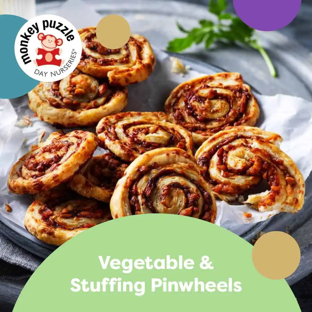 Vegetable Pinwheels Crispy vegetable and stuffing pinwheels served on a black tray with parchment paper, ideal for kids' snacks or lunchboxes.