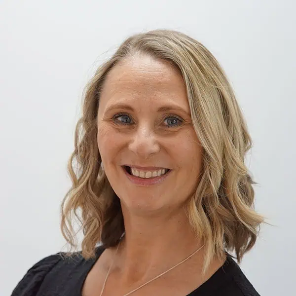 Friendly female childcare professional at Monkey Puzzle Day Nurseries, promoting quality early childhood education and nurturing care for young children.