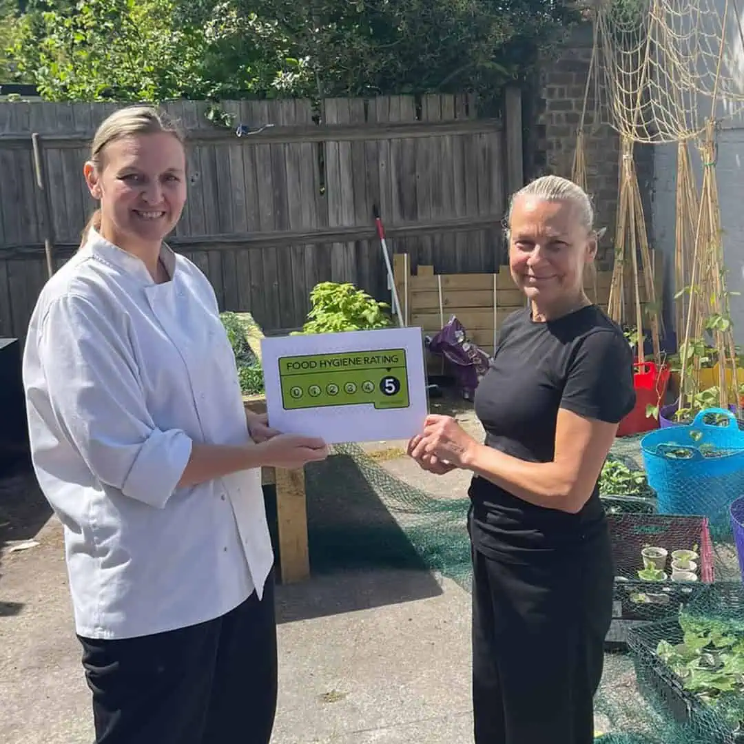 Food hygiene rating being awarded at Monkey Puzzle Day Nurseries outdoor environment, demonstrating commitment to health and safety standards for early childhood education.