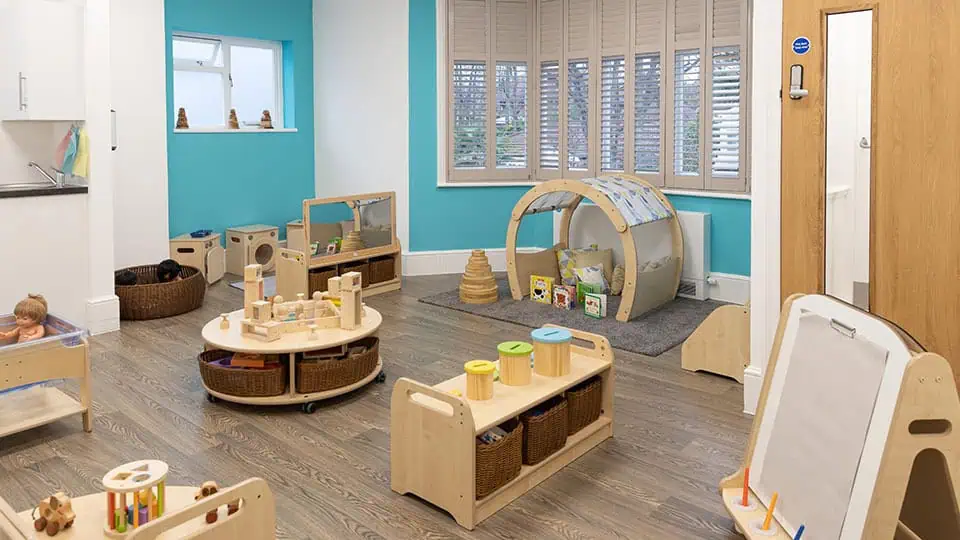 Bright, welcoming indoor playroom at Monkey Puzzle Day Nurseries with age-appropriate toys and cozy areas for early childhood development. Perfect for nurturing children's imagination and learning.