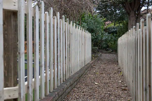 Wooden fence surrounding childcare outdoor play area at Monkey Puzzle Day Nurseries, safe and secure environment for young children attending the nursery.