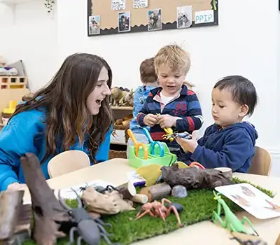 Nursery Practitioner working with children in a nursery