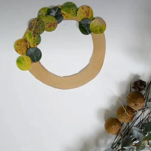 Green and yellow leaf wreath decor for nursery or children's room, eco-friendly wall art, natural design element, playful and calming floral wall decoration for kids' spaces, Monkey Puzzle Day Nurseries.