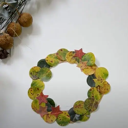 Colorful autumn leaf wreath made from real leaves, perfect for children’s seasonal crafts at Monkey Puzzle Day Nurseries. Ideal for engaging early childhood creativity and learning activities.