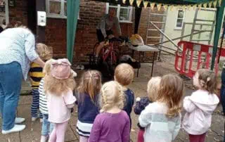 Children supporting Andy on his bike ride Monkey-puzzle-day-nurseries-outdoor-safety-activities.jpg|A group of young children watching a safety demonstration outdoors at Monkey Puzzle Day Nurseries, highlighting outdoor learning and nursery safety programs.|Children at Monkey Puzzle Day Nurseries observing an outdoor safety demonstration, engaging in hands-on learning activities that promote safety awareness and social development in a caring nursery environment.|A group of diverse young children gathered outdoors at Monkey Puzzle Day Nurseries, attentively watching a safety demonstration led by an instructor. The scene captures the nursery's focus on outdoor activities, safety education, and fostering curiosity in early childhood development, set against the backdrop of a brick building and autumn trees.|relevant.