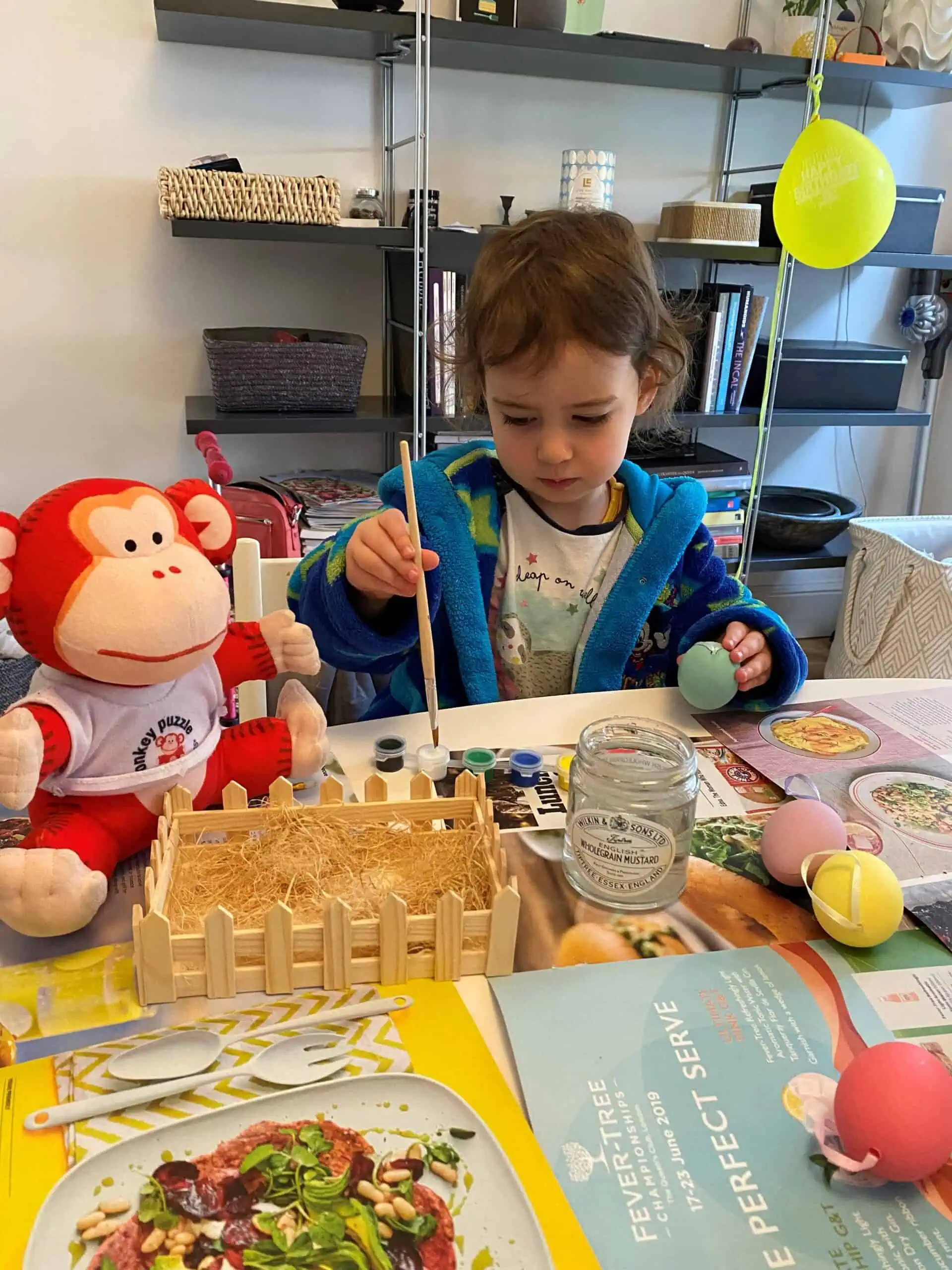 Painting Easter eggs with children at Monkey Puzzle Day Nurseries for festive activities and creative play.