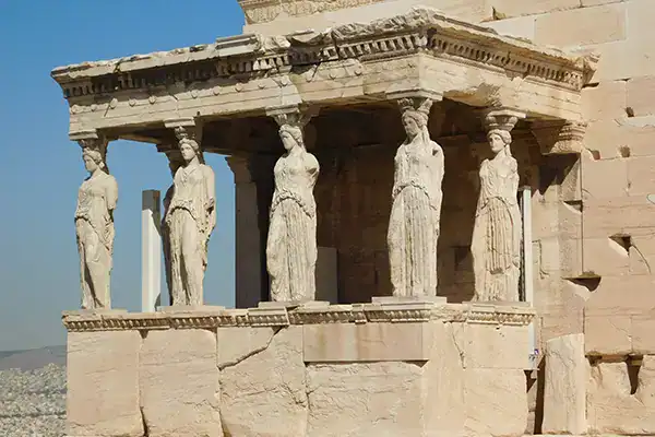 Ancient Greek style sculptures on a historical temple structure, showcasing classical architecture and artwork. Ideal for educational content about Greece and ancient civilizations.