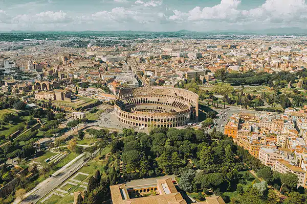 Colosseum in Rome aerial view, Italy, showcasing ancient Roman architecture and historic landmarks.