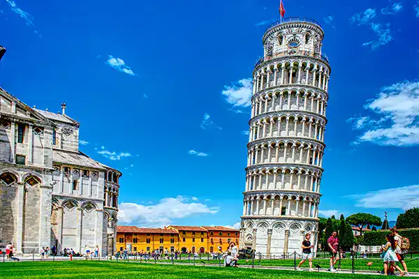 Pisa Tower in Italy at Piazza dei Miracoli, famous for its architectural tilt and tourist attraction, surrounded by historic buildings and visitors enjoying the scenic views.