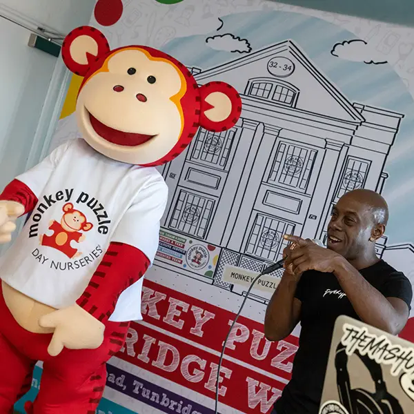 Marvin the Monkey with DJ Pied Piper at a nursery Christmas event