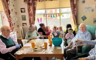 Care home activity with elderly and young children in a daycare setting, fostering intergenerational bonds, social interaction, and community engagement at Monkey Puzzle Day Nurseries.