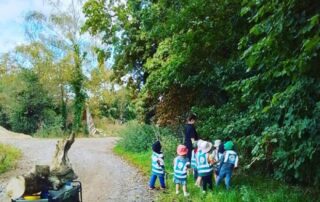 Nursery children exploring nature in their local area