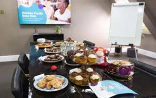 Delicious homemade baked treats and cupcakes set up for a children’s event at Monkey Puzzle Day Nurseries, creating a fun and engaging environment for kids' activities and celebrations.
