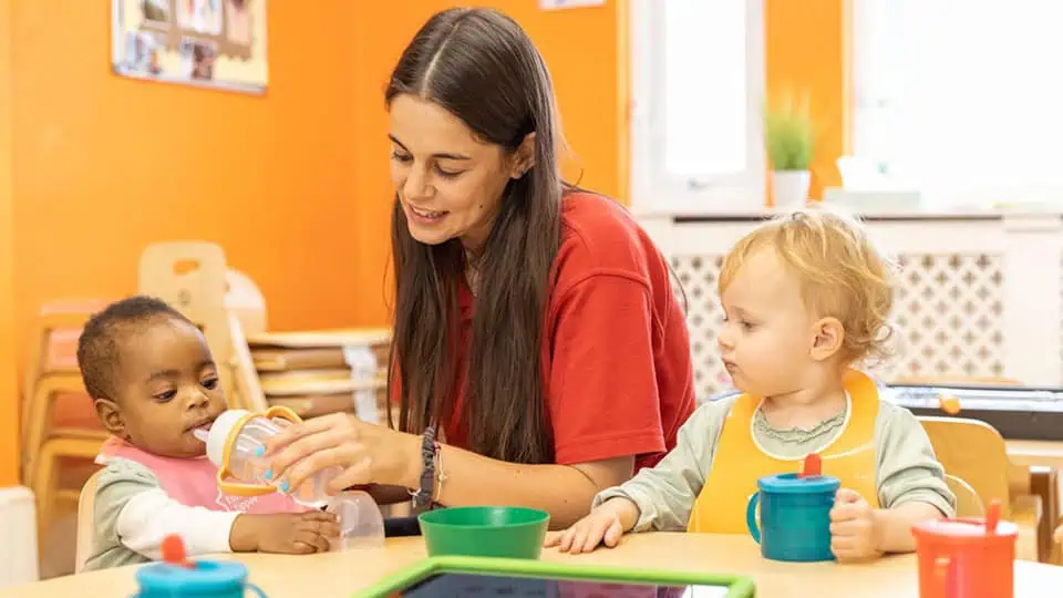 Babies lunch time Baby feeding activities at Monkey Puzzle Day Nurseries, nurturing early childhood development, caring childcare environment, preschool learning, toddler nutrition, happy children in nursery setting.