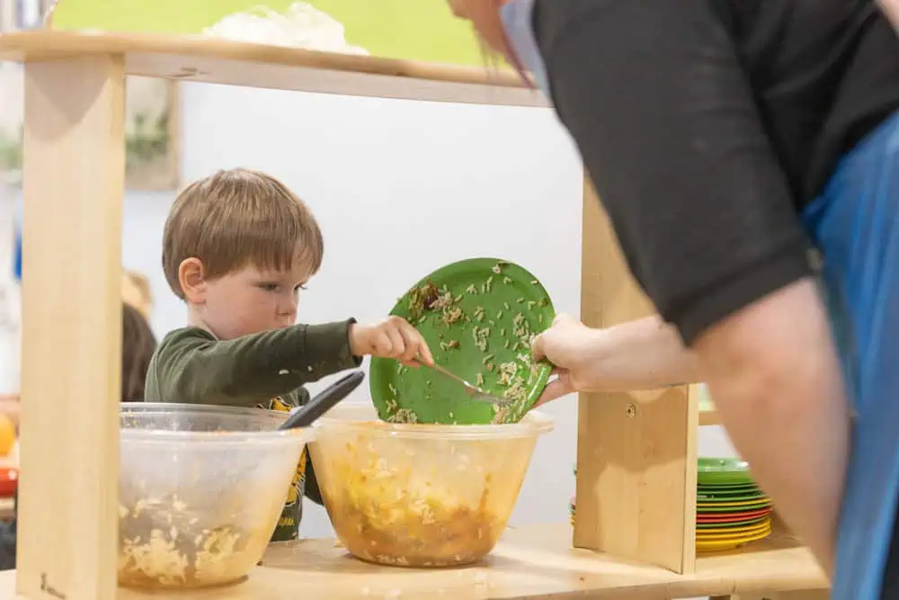 Healthy eating Children engaging in cooking activities at Monkey Puzzle Day Nurseries, promoting early learning and development.
