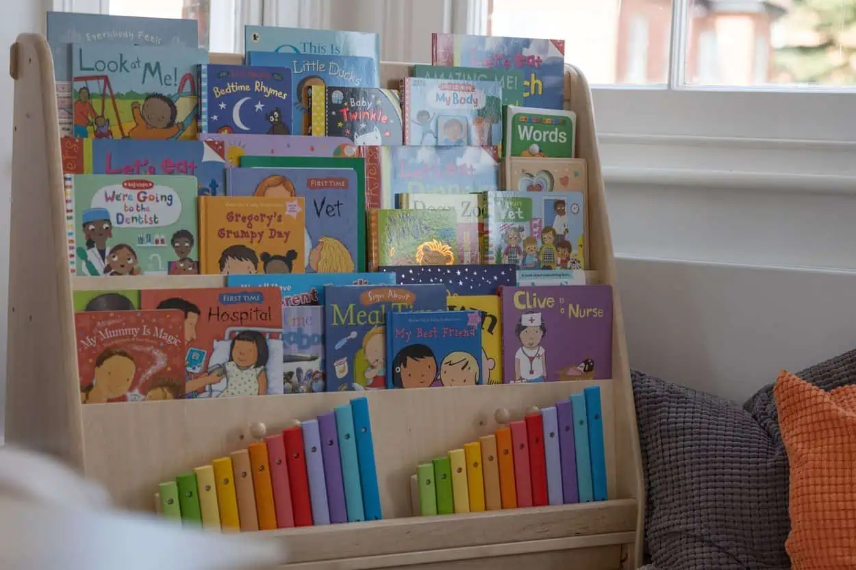 Reading areas Board book display at Monkey Puzzle Day Nurseries showcasing a variety of colorful children's books for early childhood development.