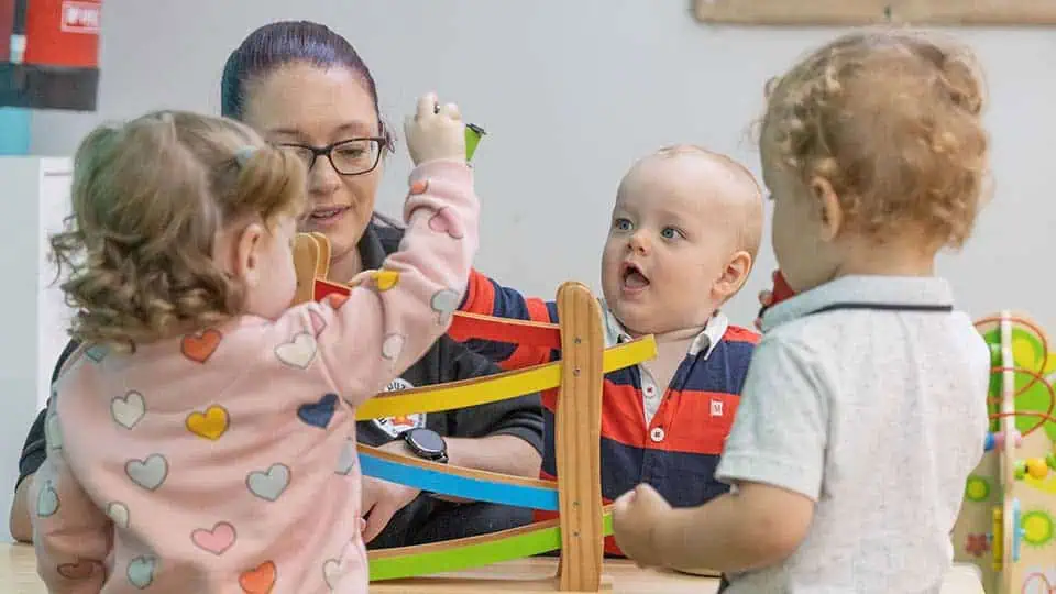 Toddlers playing together Children playing with educational toys at Monkey Puzzle Day Nurseries, engaging in interactive learning activities.