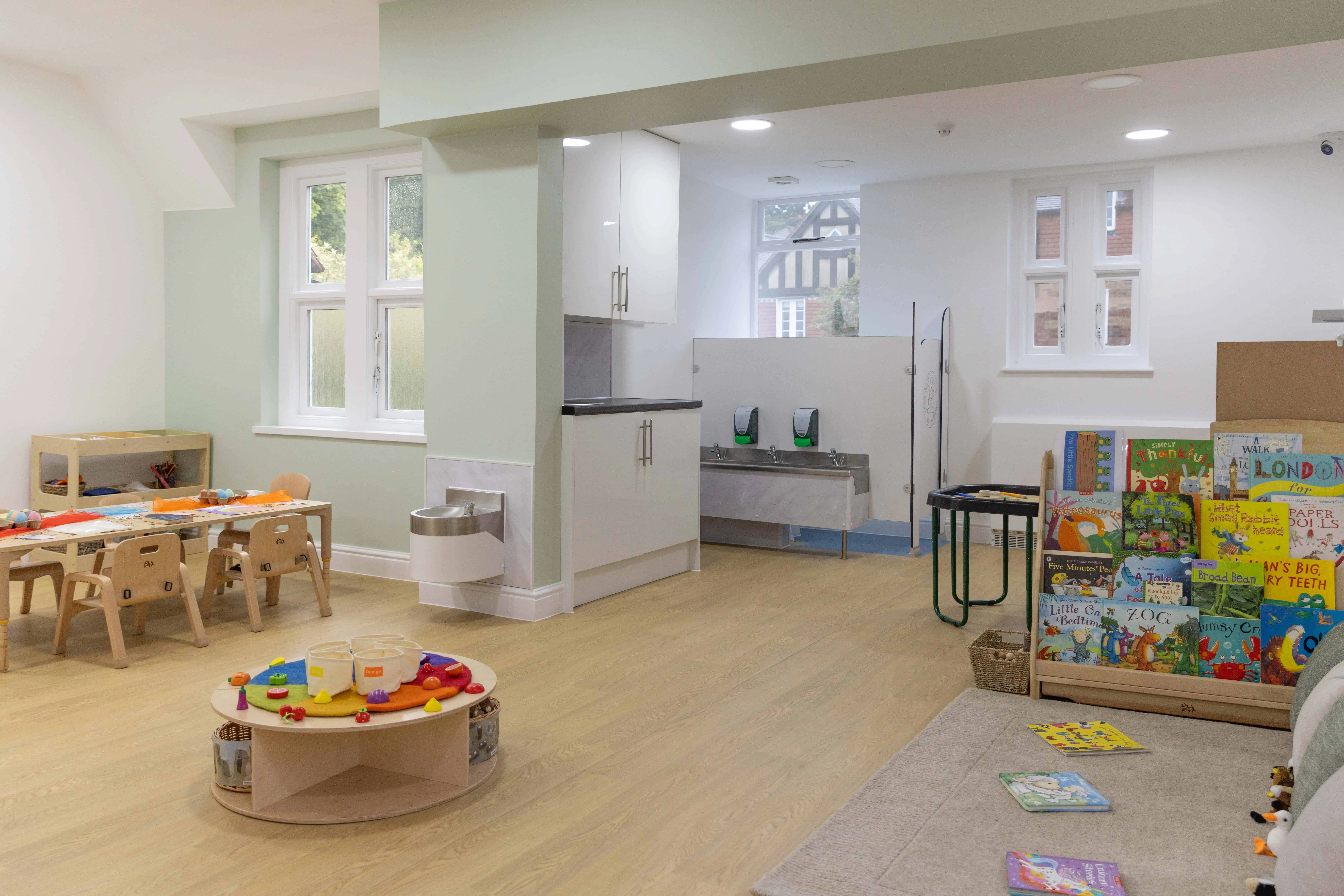 Bright and spacious indoor play area at Monkey Puzzle Day Nurseries, featuring child-friendly furniture, educational toys, and a reading corner to promote early learning and development.