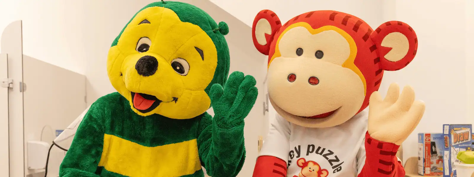 Colorful monkey and lion plush mascots at Monkey Puzzle Day Nurseries, creating a fun and engaging environment for young children. Perfect for promoting early childhood development and joyful learning experiences.