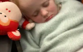 Soft toy monkey along with a sleeping child at Monkey Puzzle Day Nurseries, showcasing a safe and nurturing environment for early childhood education and play.