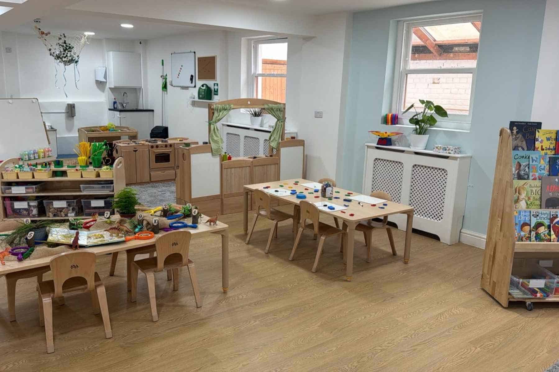 Colorful preschool classroom with educational toys, books, and learning materials, designed for early childhood development at Monkey Puzzle Day Nurseries.