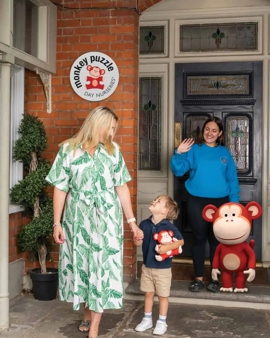 How to Thrive as a Parent and Professional (1) Monkey Puzzle Day Nurseries entrance with staff, children, and mascot.