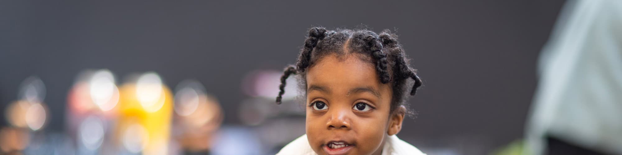 Young girl with curly hair showing a range of emotions, illustrating big feelings in children, relevant for understanding emotional development.